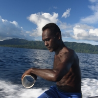 Rolling up the fishing line to be ready for the next catch.